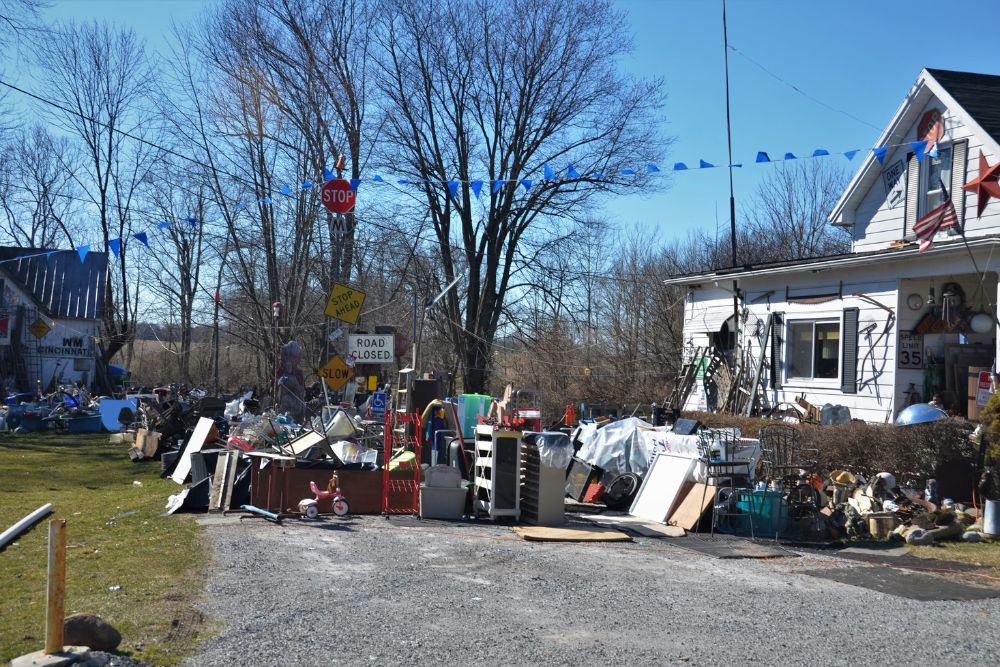 A disorganized yard filled with junk and junk cars, highlighting a large-scale junk removal service in San Francisco, CA.